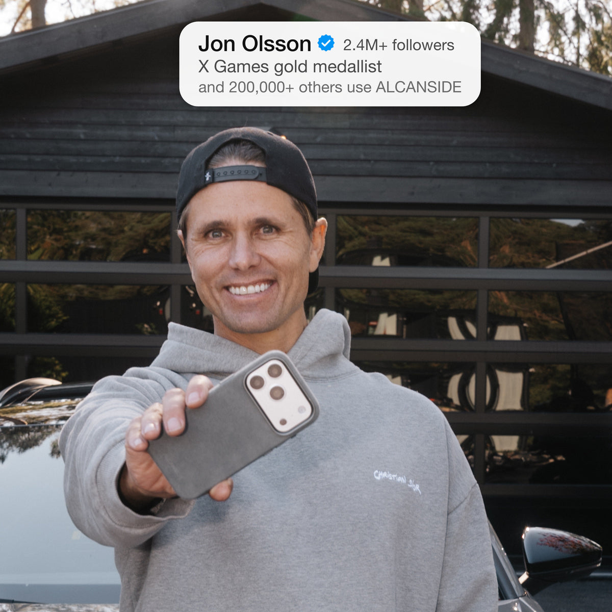 Jon Olsson holding the Nardo Gray ALCANSIDE Alcantara case #iPhone model:_iPhone 18 Pro|iPhone 18 Pro Max