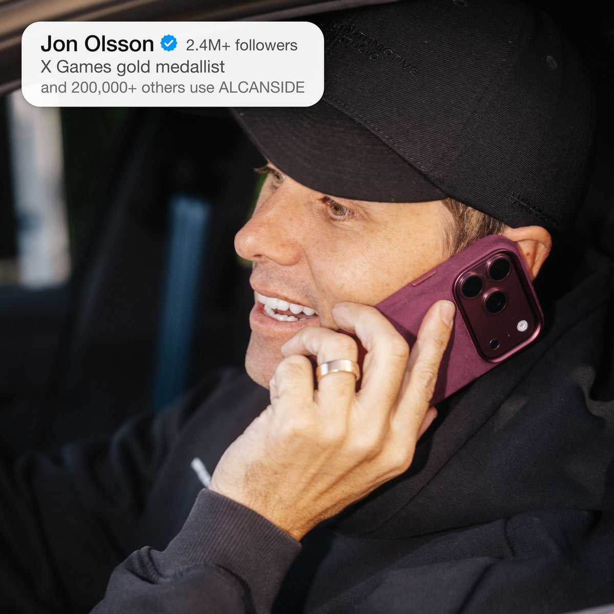 Jon Olsson with the Wine Red ALCANSIDE Alcantara case held to the ear